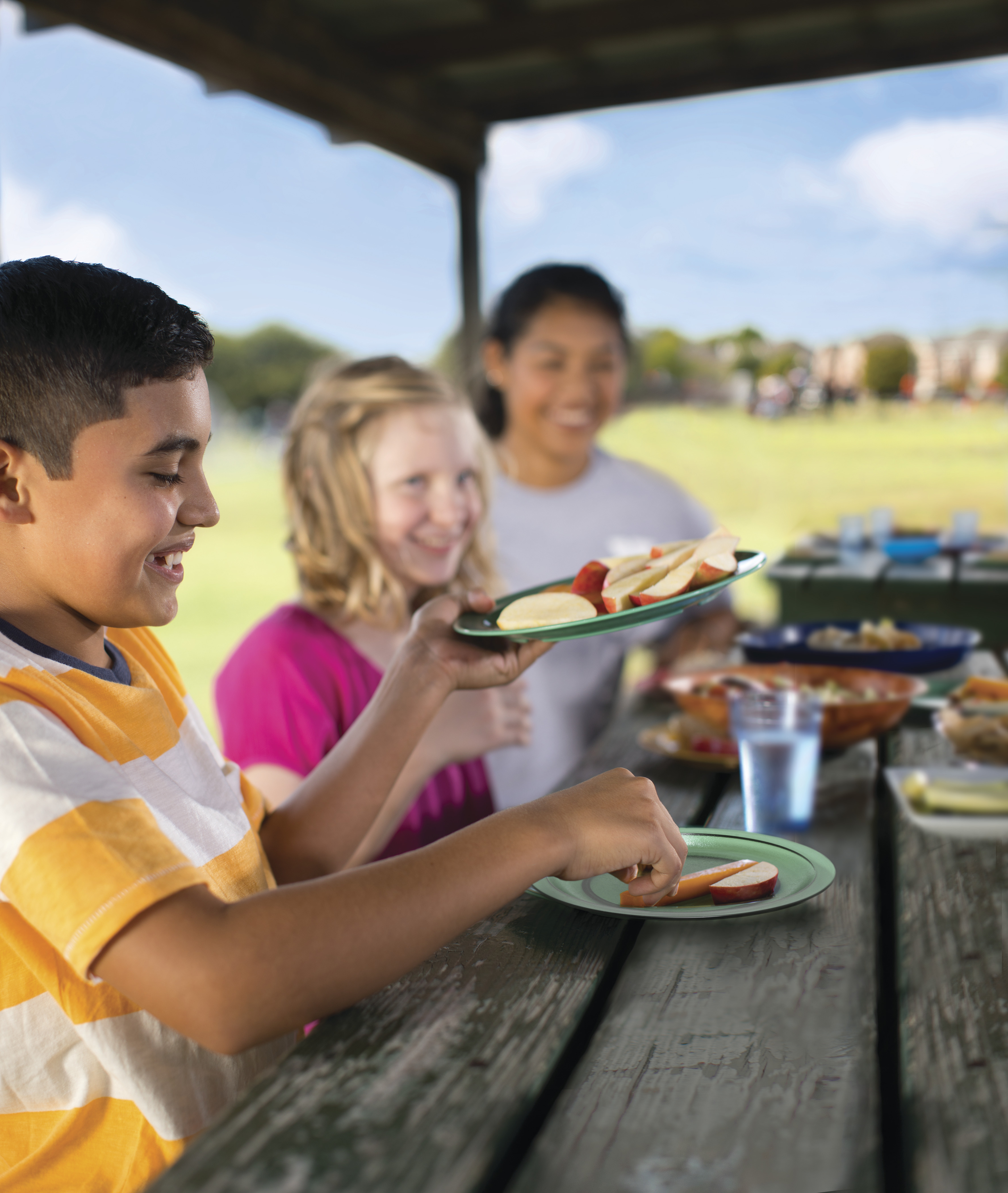 Kids eating snacks at a picnic table
