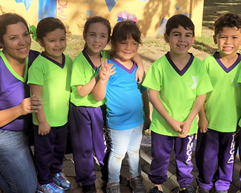 YMCA Puerto Rico staff with five preschool-age kids outside